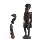 An African carved hardwood figure, 55cms (21.5ins) high; together with another similar, 40cms (15.