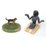 An early 20th century spelter cold painted figure in the form of a dog mounted on a green onyx pin