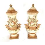 A pair of Victorian blush ivory vases and covers, decorated with a spray of flowers, 32cms (12.5ins)