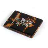 A Victorian tortoiseshell card case with mother of pearl inlaid decoration.