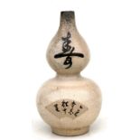 A Japanese crackle glaze double gourd vase decorated with calligraphy, 19cms (7.5ins) high (a/f).