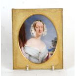 A portrait miniature depicting a young lady painted on a slab of marble with gilt metal surround, 10