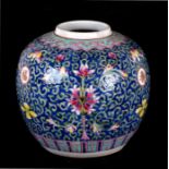A Chinese famille rose ginger jar decorated with flowers and foliate scrolls on a blue ground,