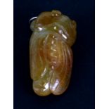 A Chinese carved russet jade / hardstone pendant in the form of a cicada on yellow metal