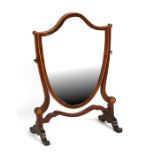 A late 19th / early 20th century shield shaped toilet mirror in mahogany frame, 37cms (14.5ins)