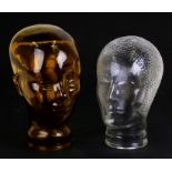 An amber glass mannikin head; together with another similar in the Art Deco style, the largest 28cms