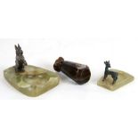 An onyx ashtray surmounted with a bronze Scottie dog figure; together with another similar and a