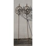 A pair of wrought iron obelisks, 165cms (65ins) high.