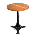 A circular pub table on a cast iron base with solid oak top, 56cms (22ins) diameter.