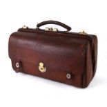 A leather Portmanteau / Gladstone case with fitted interior with nickel plated topped glass jars,