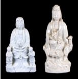 A Blanc de Chine figural group depicting Guanyin, 20cms (8ins) high; together with another