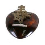 A Chinese silver and faux tortoiseshell desk top letter clip, 10cms (4ins) wide.