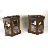 A pair of glazed walnut wall mounted corner display cabinets, 42cms (16.5ins) wide; together with
