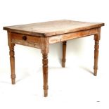 A pine kitchen table with single frieze drawer, on turned legs, 120cms (47ins) wide.