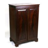 A Victorian mahogany cupboard with twin panelled doors enclosing three fixed shelves, 68cms (26.