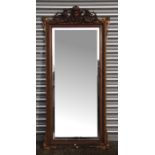 A large gilt framed bevel edged wall mirror, 71 by 15ocms (28 by 59ins).