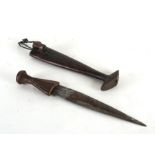 A 19th century ethnic dagger with an unusual wooden scabbard, having a cut out section so the