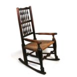 A 19th century oak and elm rocking chair with rush seat.