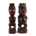 Two New Zealand Mauri Tiki carved wooden figures, the largest 28cms (11ins) high (2).