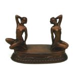 An Art Deco cold painted spelter desk weight depicting two semi clad women, 13cms (5ins) high.
