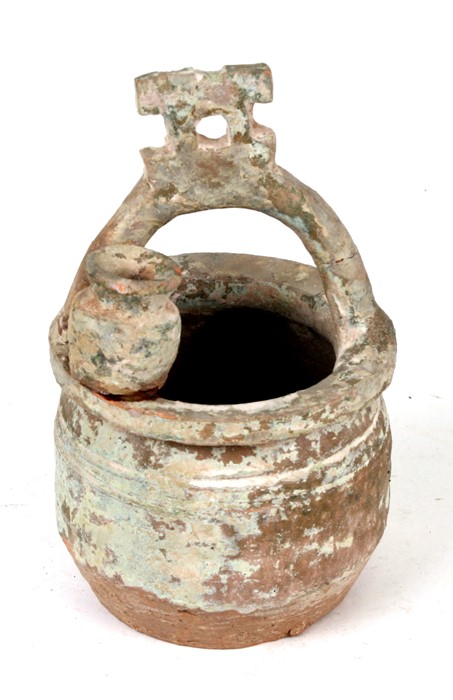 A Chinese Han dynasty pot in the form of a well, 18cms (7ins) high.