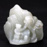 A Chinese jade boulder decorated with a figure beside a tree, 6cms (2.25ins) high.