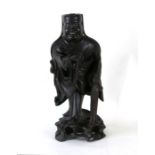A Chinese root wood figure depicting a robed man holding a string of beads and a fly whisk, 36cms (