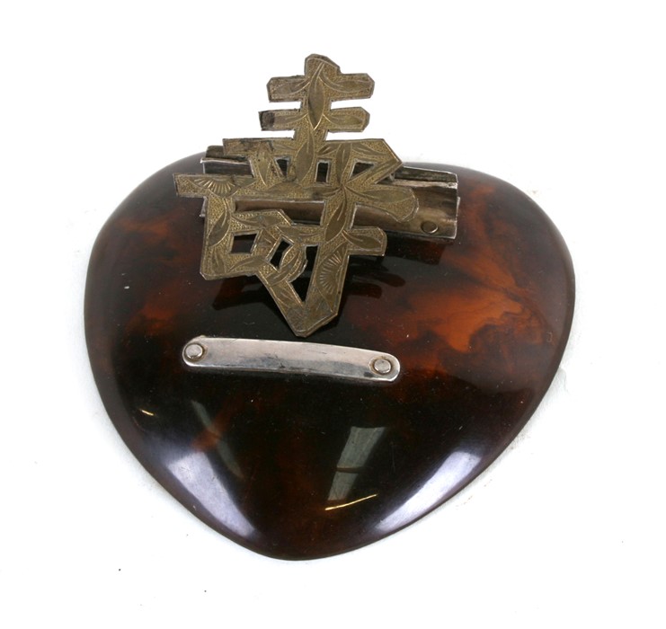 A Chinese silver and faux tortoiseshell desk top letter clip, 10cms (4ins) wide.