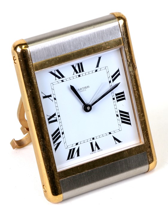 A Cartier brushed steel and brass travel alarm clock, 7.5cms (3ins) wide.Condition Reportsome