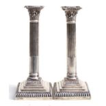 A pair of Victorian silver Corinthian column candlesticks on square stepped bases, Sheffield 1901,