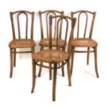 Four Thonet bentwood chairs with cane seats. All four are stamped THONET under the seat frames