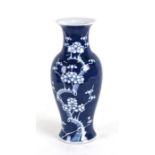 A Chinese baluster vase decorated with prunus on a blue ground, 30cms (12ins) high.Condition