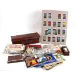 A box of assorted stamps and cigarette cards.