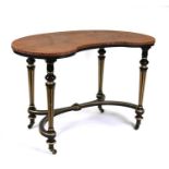 A Victorian ebonised and gilt kidney shaped dressing table, 109cms (43ins) wide.