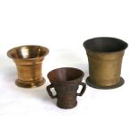 A group of three bronze and cast iron mortars, the largest 11cms (4.75ins) high (3).