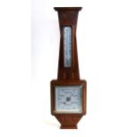 An Art Deco walnut cased barometer thermometer, 57cms (22.5ins) high.