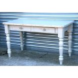 A painted pine kitchen table with two frieze drawers, on turned legs, 137cms (54ins) wide.