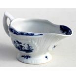 A Lowestoft porcelain sauce boat with underglaze blue decoration, with label Farleigh House -