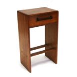 An Art Deco oak bedside table, the single frieze drawer with Macassar ebony handle, 43cms (17ins)