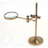A brass table top magnifier stand with tilting arm and height adjustable, approx 42 cms (16.5 ins)