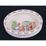 A Royal Doulton Bunnykins oval feeding bowl with Christmas Dinner scene, dating from the 1950s