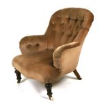 A button backed upholstered arm chair on turned front legsCondition Reportgeneral wear