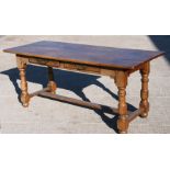 A French fruitwood farmhouse dining table with two frieze drawers, on turned legs joined by a