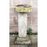 A composite stone bird bath,