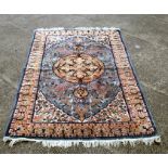 A Persian woollen hand knotted rug with central design within stylised borders, on a cream ground,