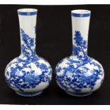 A pair of large Japanese blue and white porcelain bottle vases decorated with chrysanthemums and