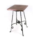 An Arts & Crafts wrought iron occasional table with square copper top, 36cms (14ins) wide.
