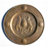 A large brass charger with central Heraldic style crest, 58 cms (23ins) diameter.