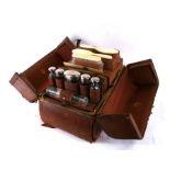 A Victorian gentleman's leather vanity case by Fisher of London, containing silver topped cosmetic