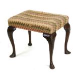 A Georgian style mahogany stool with upholstered seat, on shell capped cabriole legs with pad